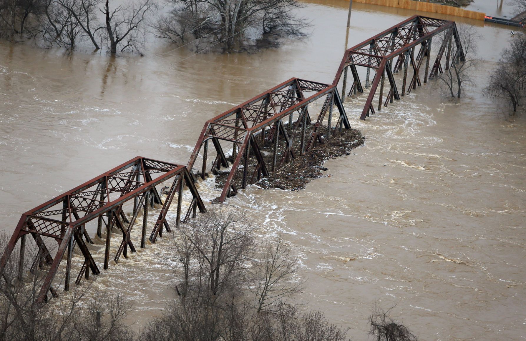 Meramec River floodwater flows over train trestle